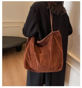 Detail view of large retro brown suede tote bag showing its spacious design and texture