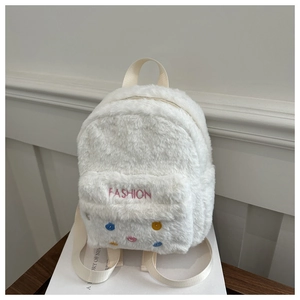 Detail of white plush backpack featuring colorful button accents and FASHION embroidery
