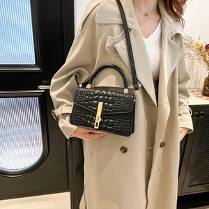 Chic black crocodile pattern handbag with gold hardware and removable shoulder strap