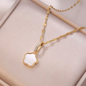 Golden flower pendant necklace with white shell inlay and zircon accents on a chain
