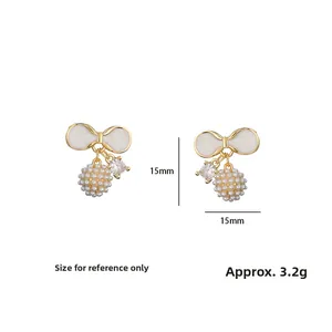 Detail view of gold bow earrings with pearl clusters and zircons measuring 15mm by 15mm