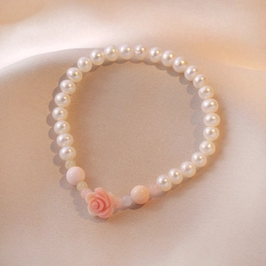 S925 freshwater pearl bracelet featuring a pink rose charm and quartz on champagne silk