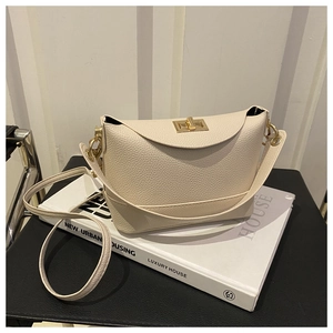 Detailed shot of cream lychee texture leather crossbody bag with gold rotating lock