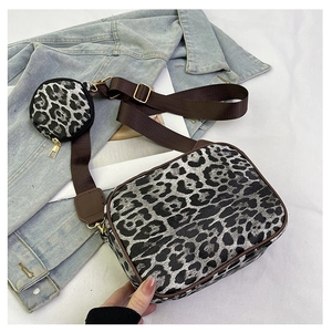Detail view of leopard print bag set with round pouch on a brown wide strap
