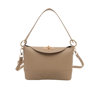 Chic beige bucket bag with lychee texture and gold metal clasp in minimalist style
