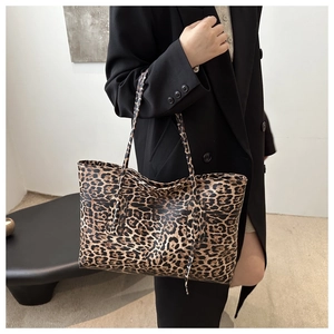 Chic leopard print tote bag styled with a dark blazer for a high-fashion look