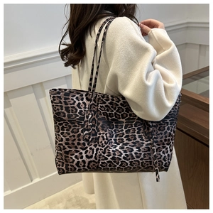 Chic leopard print large tote bag made of premium PU leather worn by a model in a studio