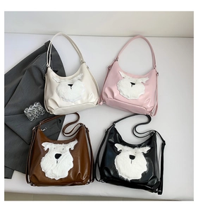 Multiple colors of PU leather tote bags with plush dog pattern in a minimalist setting