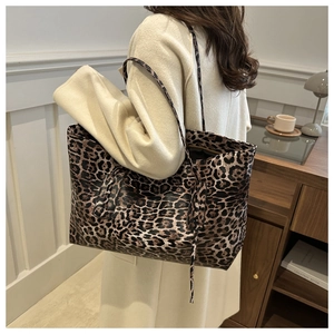 Detailed view of leopard print tote bag with high-quality leather texture and slim strap