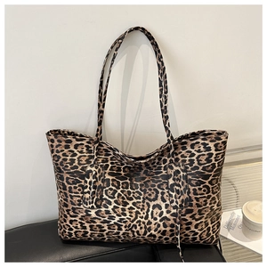 Close-up of leopard print tote bag on leather seat showing detailed canvas texture