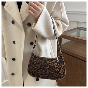 Leopard print hobo bag worn with a cream coat showing stylish texture and pattern