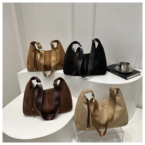 Detail of matte leather tote bags in four colors with wide shoulder straps and drawstring charm
