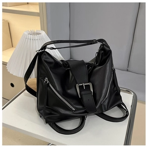 Détail du sac à dos en cuir PU noir avec grande boucle argentée et zips latéraux