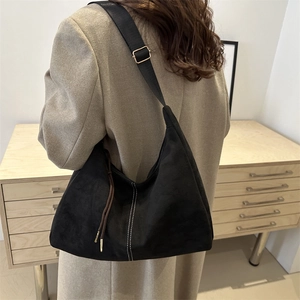 Retro black suede tote bag with white stitching and wide shoulder strap for women