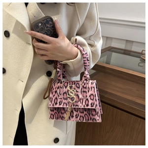Close-up of pink leopard print mini bag with gold S-logo and metal tassel details
