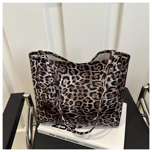 Detail of high-capacity leopard print canvas tote bag with long shoulder straps