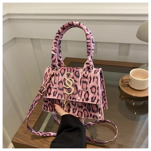 Detail of pink leopard faux fur handbag with golden S logo and metallic tassels