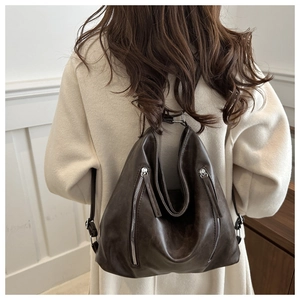 Dettaglio della borsa hobo vintage in pelle PU marrone con cerniere sulla schiena