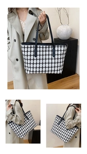 Detail of black and white checkered tweed tote bag with premium leather handles