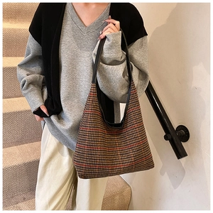 Detailed view of the vintage houndstooth fabric texture on this large hobo shoulder bag