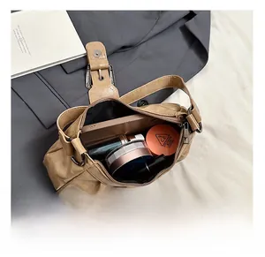 Interior view showing the large capacity of the khaki shoulder bag for daily essentials