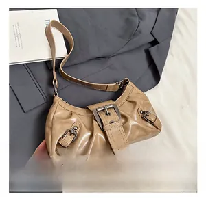 Detail of khaki faux leather shoulder bag with metal buckle and pleated design