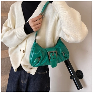 Green crescent hobo bag with vintage buckle and pleated leather texture on model