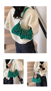 Detail of green patent leather hobo bag with vintage metal buckles and adjustable strap