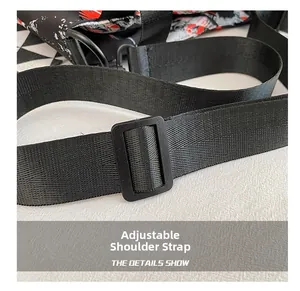 Detail of adjustable black nylon shoulder strap with plastic buckle and graffiti print