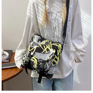 Street style nylon messenger bag with bold graffiti patterns and buckle closure detail