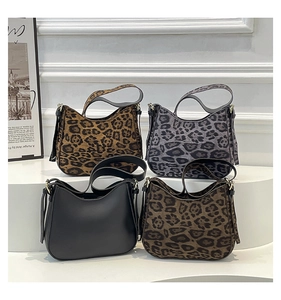Detailed display of four hobo bags in black and leopard prints with golden hardware