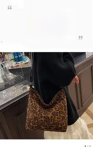 Detail of leopard print tote bag in soft faux suede material for a trendy autumn look