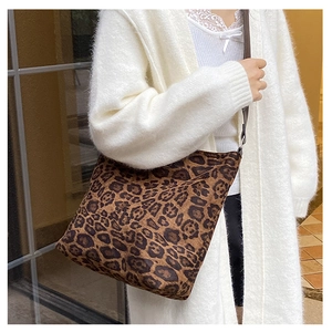 Detailed view of the large leopard print tote with adjustable brown shoulder strap