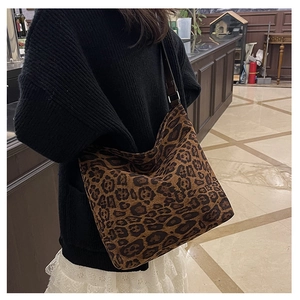 Leopard print tote bag showing large capacity and soft suede texture on a female model