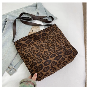Detail of leopard print large capacity tote with adjustable brown leather shoulder strap