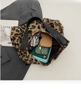 Detailed view of the leopard print plush tote bag showing its spacious inner compartment