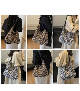 Detail view of plush leopard print tote bags with black leather straps on a female model