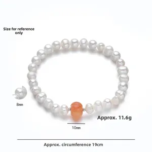 Detail view of 8mm freshwater pearls and 10mm orange agate bead on S925 silver bracelet