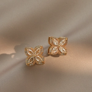 Elegant gold plated four-leaf clover stud earrings with marquise-cut clear zircon stones