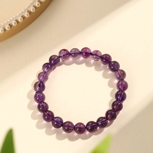 Natural deep purple Uruguay amethyst bead bracelet displayed on a premium white textured background
