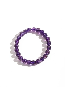 Macro view of Uruguay amethyst bracelet with transparent purple beads and natural texture