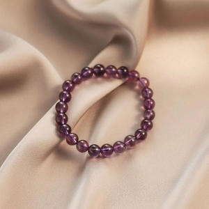 Uruguay purple amethyst beaded bracelet for women displayed on elegant silk fabric