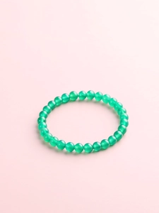 Macro detail of emerald green natural agate beads with smooth polished texture