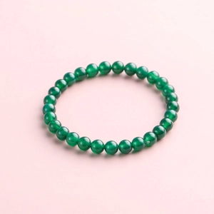 Natural green jade bead bracelet featuring polished nephrite beads on elastic cord