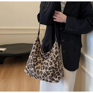Close-up of leopard print faux fur tote bag with textured plush finish and black handles