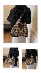 Detail of the soft faux fur leopard print shoulder bag with a black wide strap
