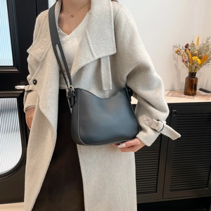 Minimalist black wave-edge leather shoulder bag with adjustable strap for women