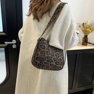 Fashionable leopard print underarm bag for women worn over the shoulder in a minimalist style