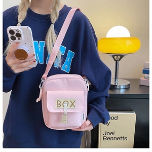 Cute pink canvas crossbody bag with bear charm and adjustable strap for girls