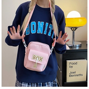 Pink canvas crossbody bag featuring a cute bear pendant and casual streetwear style
